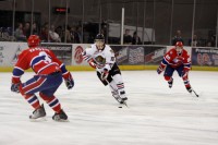 Top class Canadian: The Winterhawks Brad Ross (middle, #18) weaves his way across the ice between two defenders.