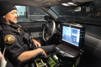 Traffic officer Mike Villanti shows off the video camera installed in his squad car.