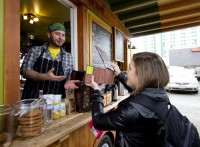 Functional art: Sophomore Jessica Herborne presents her freshly finished tip jar creation to the Portland Soup Company food cart, part of the Southwest Fourth Avenue’s foodcart pod.