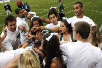 School spirit: The Portland State spirit squad huddles together during a football game this fall and prepares to help fire up the crowd.