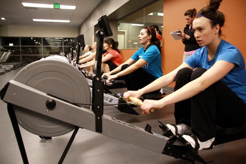  Crew members: Jessica Hacker (center) and Michelle Matchulat (right) practice in the Rec Center. Viking rowers will use rowing machines in their first competition of the year.
