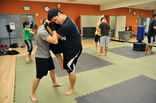 Hard knocks: Kickboxing club members practice fighting from the Clinch during a meeting. The club started with a focus on kickboxing, but has grown to include various martial arts styles.