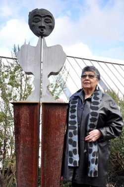 Lillian Pitt stands next to one of her sculptures outside the Native American Student and Community Center.
