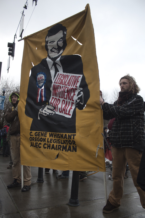 One banner criticized ALEC State Chairman Rep. C. Gene Whisnant.