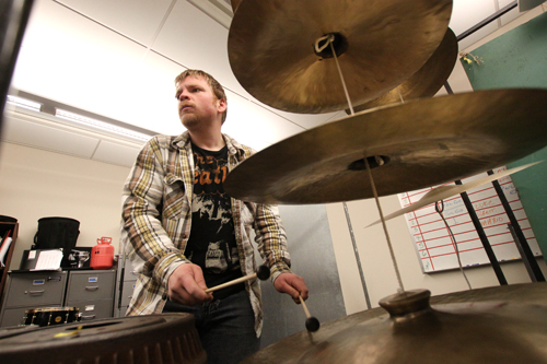 Brett Dvirnak plays a hanging stack of chinese and turkish cymbals