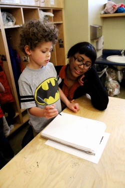 Dojonique Grittman, a chemistry senior, works with her son, Adam, at the Children’s Center. Grittman organized the parent petition for summer childcare funding from ASPSU.