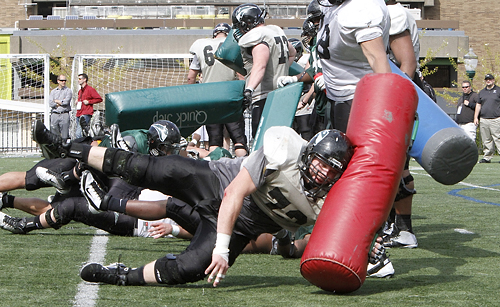 Fit to hit: Offensive linemen practice lunging into bags. PSU has many veterans options at OL. Their roster has four seniors and four juniors. 