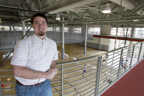 Fun on the run: Spencer Sorenson, intramurals coodinator, poses on the running track in the Academic and Student Rec Center. Below, students play a pick-up game of basketball.