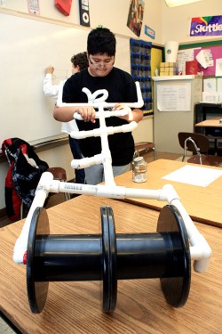 Innovated transportation: a Mt. Tabor Middle School student works on developing a solution to transport five gallons of water over distances.