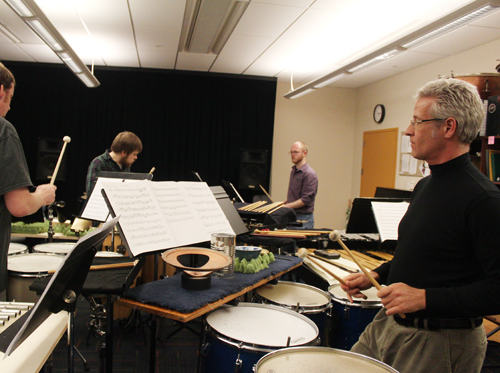 Peyton, right, leads the percussion ensemble in preparation for Thursday’s performance.