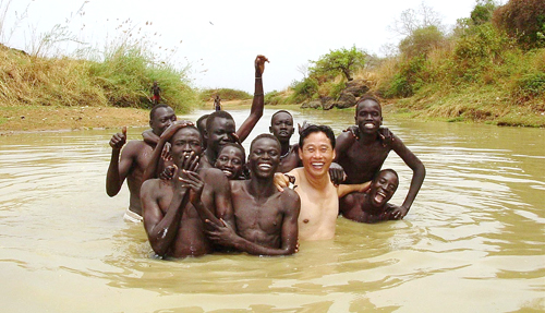 Tae-Suk Lee from Korea splashes about with his Sudanese friends.
