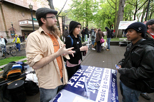 Graham Smith of Fair Trade Music works a booth at the May Day events in the Park Blocks.