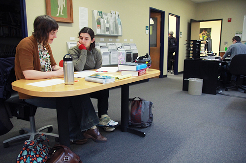 Write on PSU students Alissa Nielsen and Elizebett Eslinger look over an essay in the Writing Center.