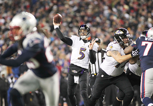 Joe Flacco launches a pass against the New England Patriots in the AFC Championship game Jan. 20. Flacco threw for three for three touchdowns in the upset, which was just the third home playoff loss for the Patriots in franchise history. Phoot © Stew Milne/ USA Today Sports.