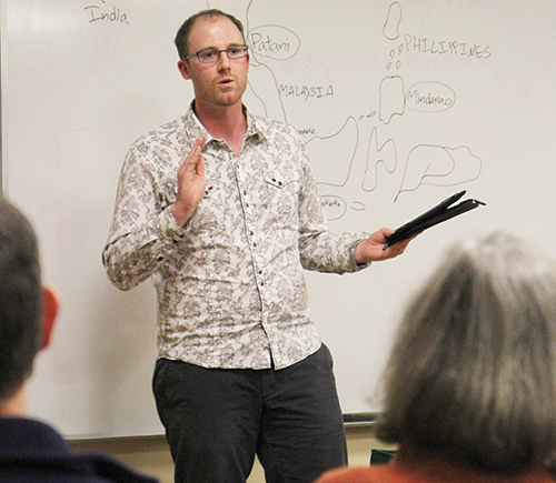 Shane Barter, a professor at Soka University of America, weighed the religious element in Southeast Asian wars at a Wednesday presentation. Photo by Kayla Nguyen.