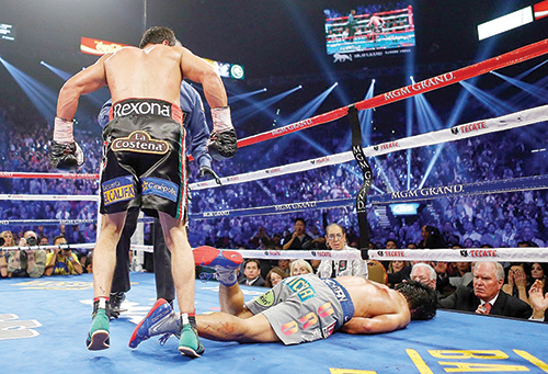 Parting shot: Eight-division champion and future Hall of Famer Manny Paquiao lays prone on the canvas after being knocked out cold by Juan Manuel Marquez during their fourth bout in December.  Photo © Al Bello/ Getty Images North America.