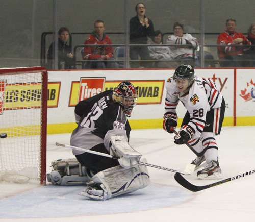 Brendan Leipsic gets the puck past Vancouver goalie Jared Rathgen in overtime on Saturday, giving Portland a 4-3 victory. Photo by Karl Kuchs.