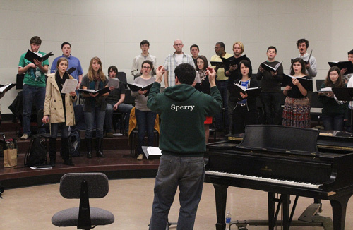 Choir director ethan sperry leads the PSU Chamber Choir during a recent rehearsal. The choir will perform at the prestigious Seghizzi International Choral Competition this summer. Photo by Corinna Scott.