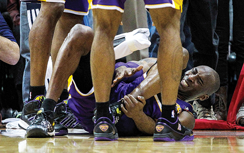 Kobe Bryant goes down with an injury against the Atlanta Hawks on March 13. With millions of dollars on the line, professional athletes are searching for alternative medical treatments. Photo © Daniel Shirey/USA TODAY sports
