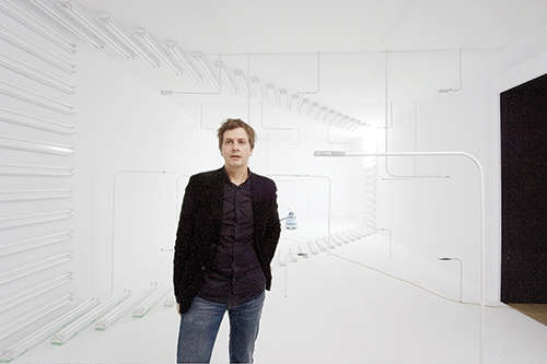 In the white room… Paris-based architect Phillippe Rahm stands in a room he designed. He “explores the effect on the human body of the energy in a space.” Photo by © archinect.com