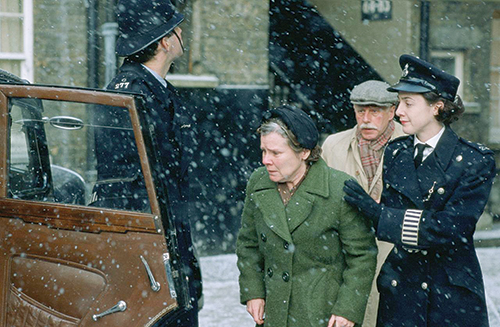 Keep calm and watch your head: The authorities hustle Vera Drake (Imelda Staunton) off to jail in a scene from Mike Leigh's 2004 film. Photo @ New line cinema.