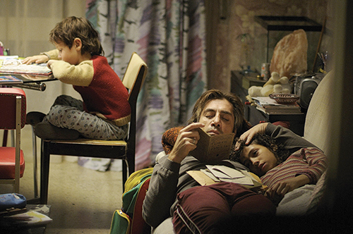 Proud papa Uxbal (Javier Bardem) watches over his two children in this still from Alejandro Gonzalez Inarritu’s 2010 film, Biutiful. Photo by © Roadside Attractions