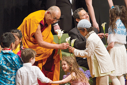 Children presented flowers to the Dalai Lama during his three-day visit to Portland last week. Photo by Karl Kuchs.