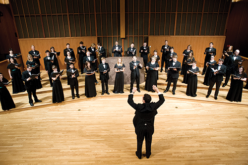 The PSU chamber choir performs under the direction of its conductor, Ethan Sperry. Sperry and the choir will be heading to Italy this summer to perform at a prestigious choral competition. Photo © Brian Lee