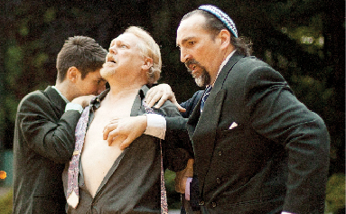 Paid in flesh: Shylock (R. James Peck) preps to remove a pound of flesh from Antonio’s (Michael Streeter) chest after the Venetian merchant fails to pay back a loan. Photo by Miles Sanguinetti