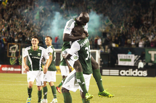 Andrew Jean-Baptiste lifts up teammate Futty Danso after scoring the game-winning goal for the Timbers. Photo by Miles Sanguinetti