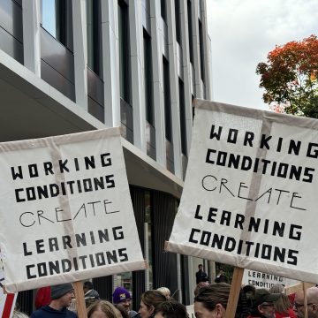 PSU-AAUP members wave picket signs with the slogan “Working conditions create learning conditions“ during a speak-out event.