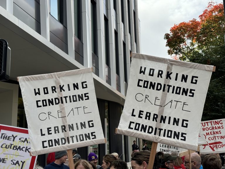 PSU-AAUP members wave picket signs with the slogan “Working conditions create learning conditions“ during a speak-out event.